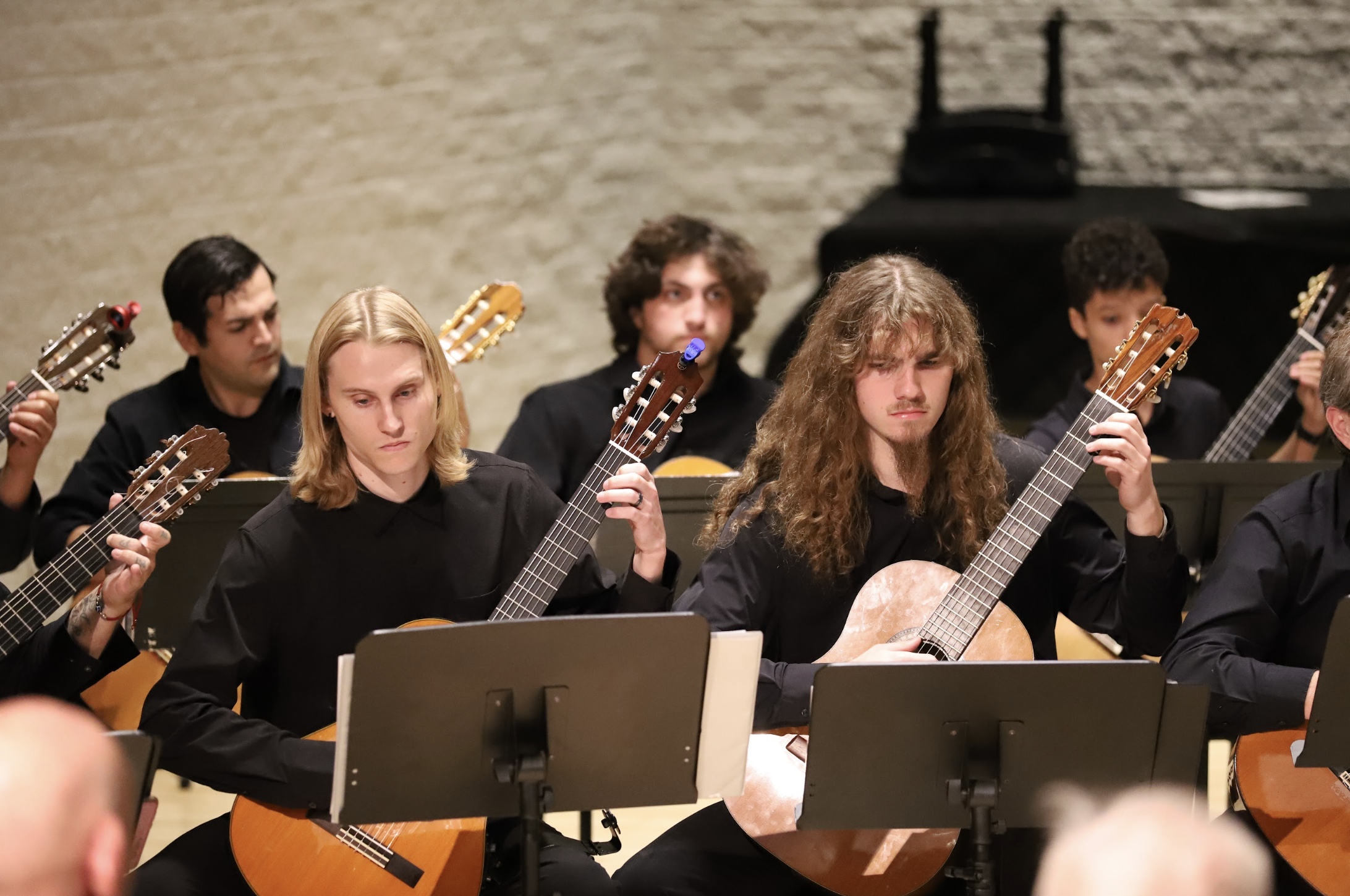 Photo of several PCC Guitar Ensemble members performing in the Recital Hall.