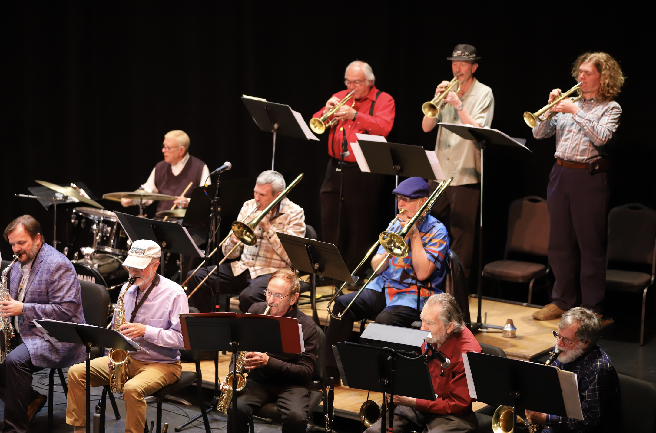 Photo of trumpet, trombone, saxophone, and percussion musicians performing with the PCC Jazz Band.