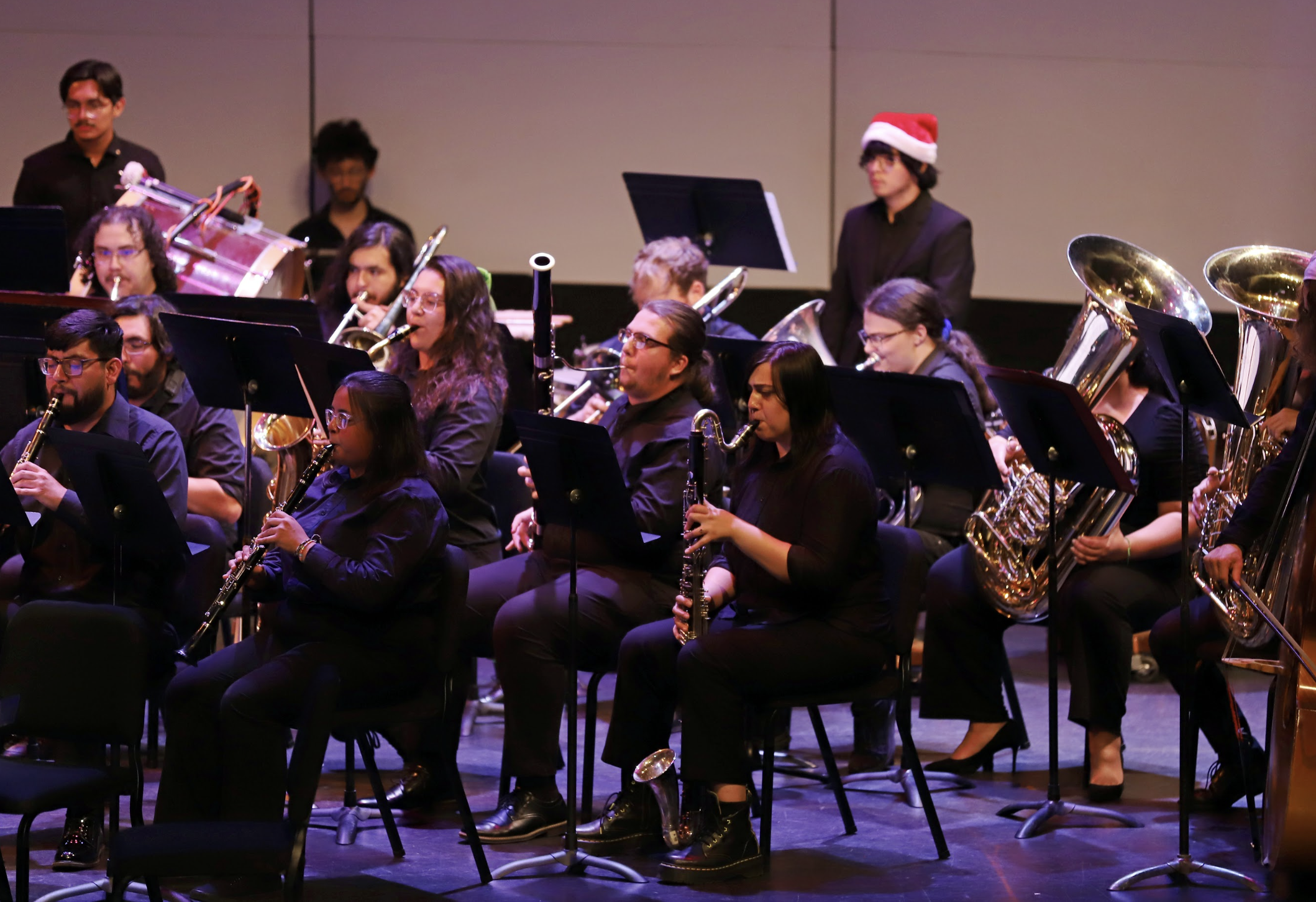 Photo of some brass, woodwind, and percussion musicians performing with the PCC Concert Band.