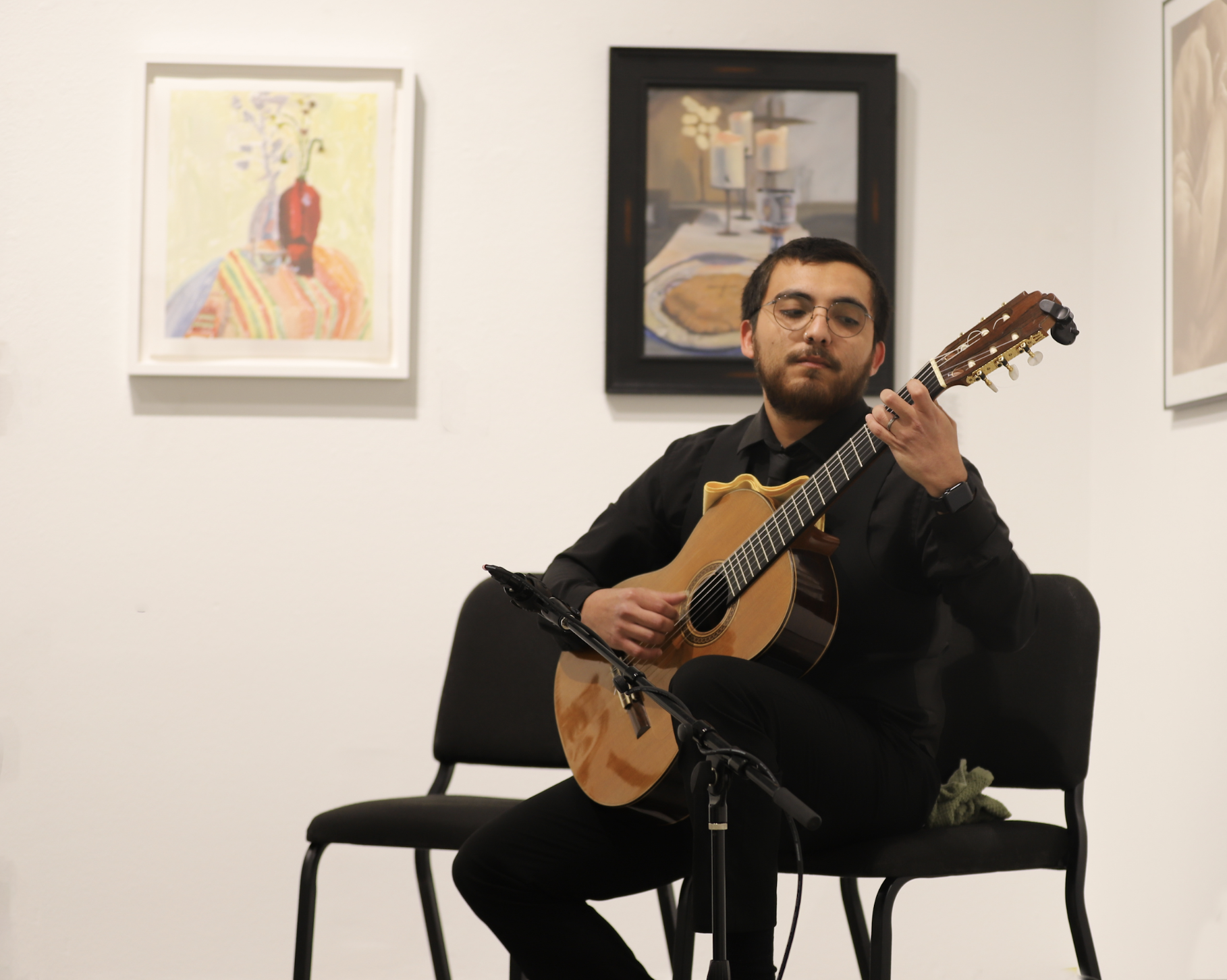 Photo of a guitar player performing in the Louis Carlos Bernal Gallery.