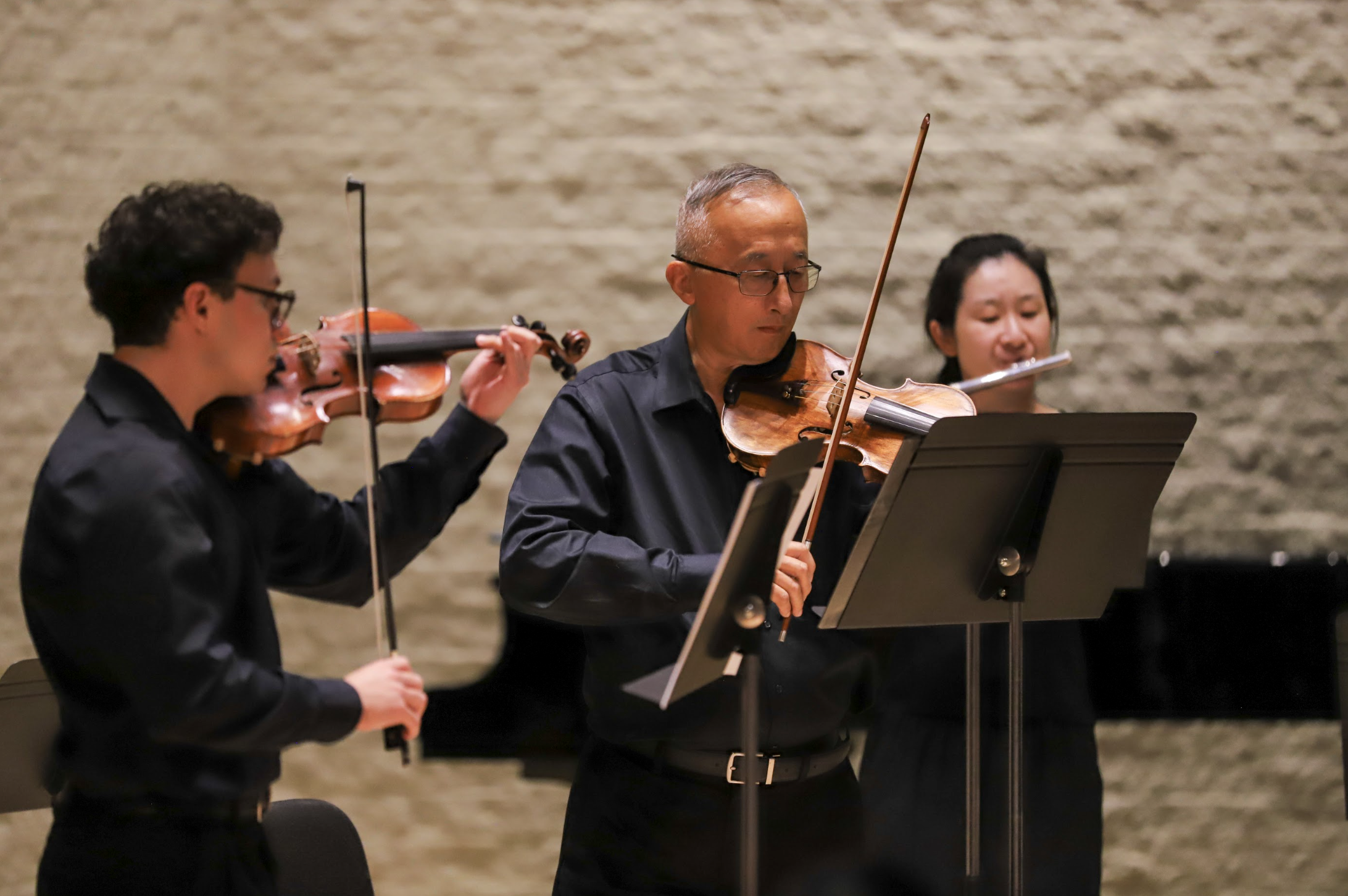 Photo of director Fang Fang Li performing with the PCC String Ensemble in the Recital Hall.