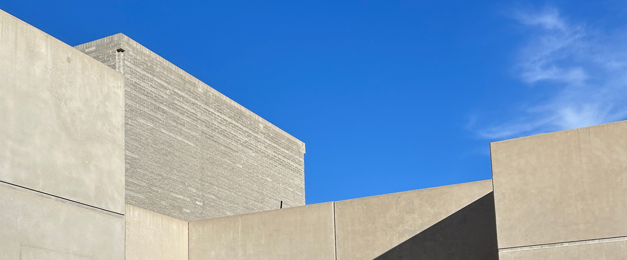 Our sleek modern campus design in front of a blue sky