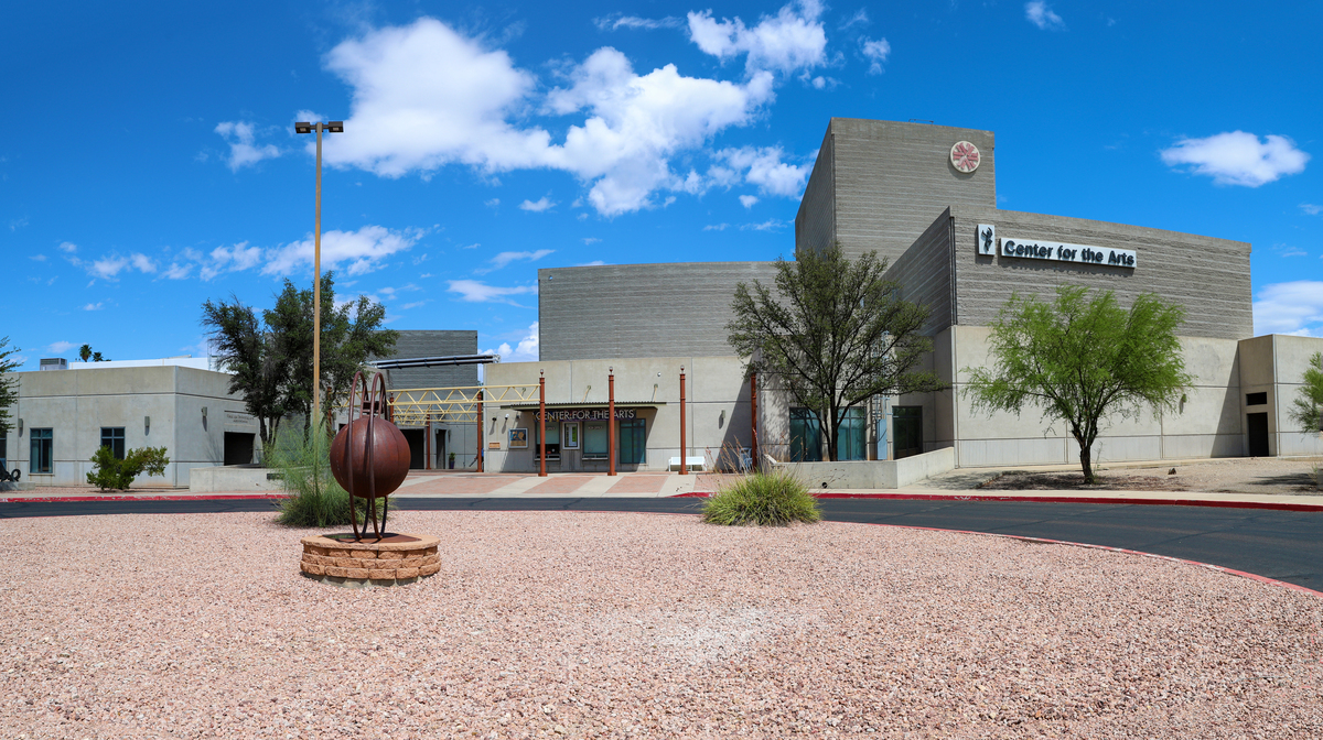 The Center for the Arts at West Campus photographed in front of a blue sky with fluffy white clouds.