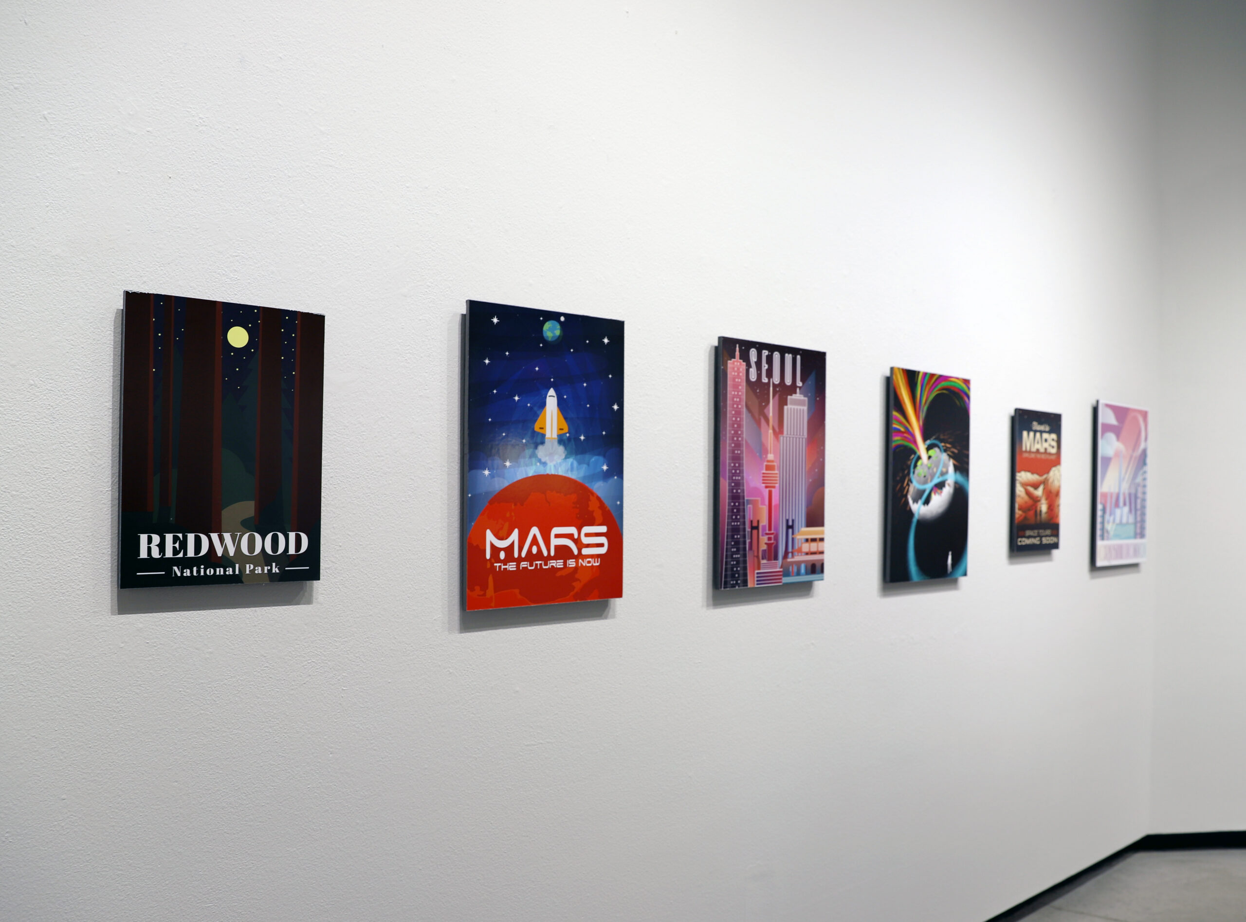 Gallery display of digital posters and illustrations.